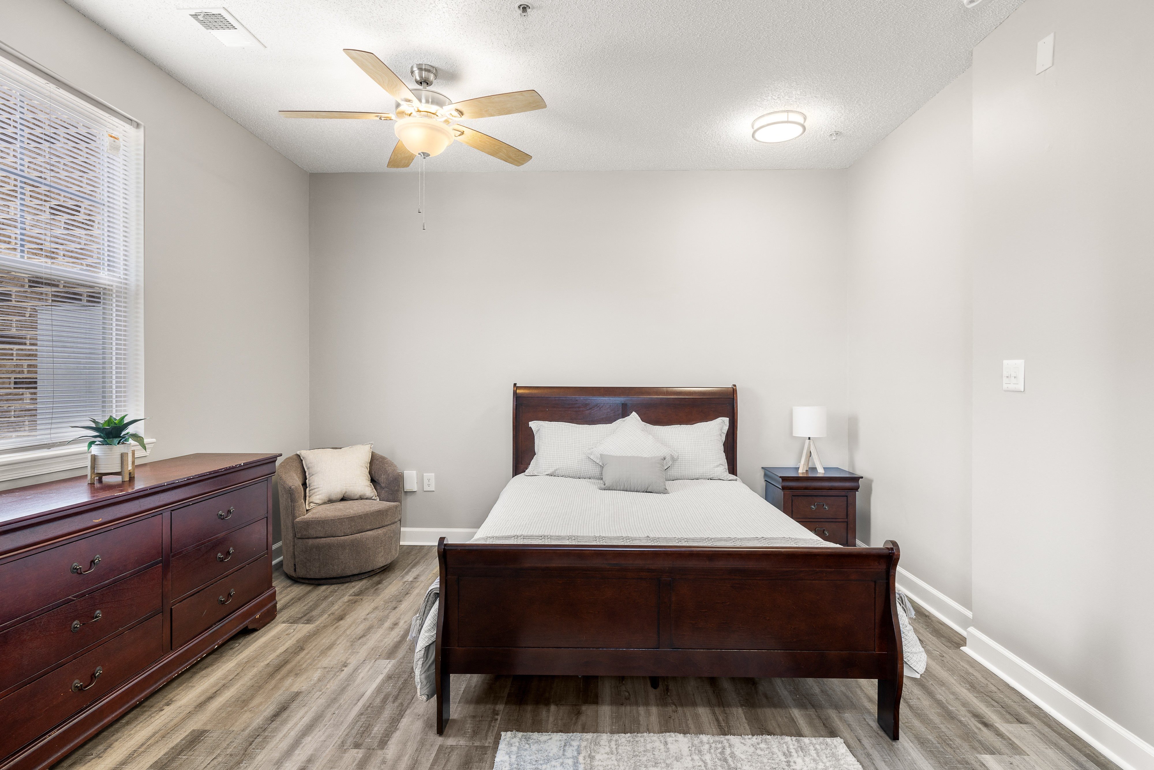 a bedroom with a bed and a ceiling fan